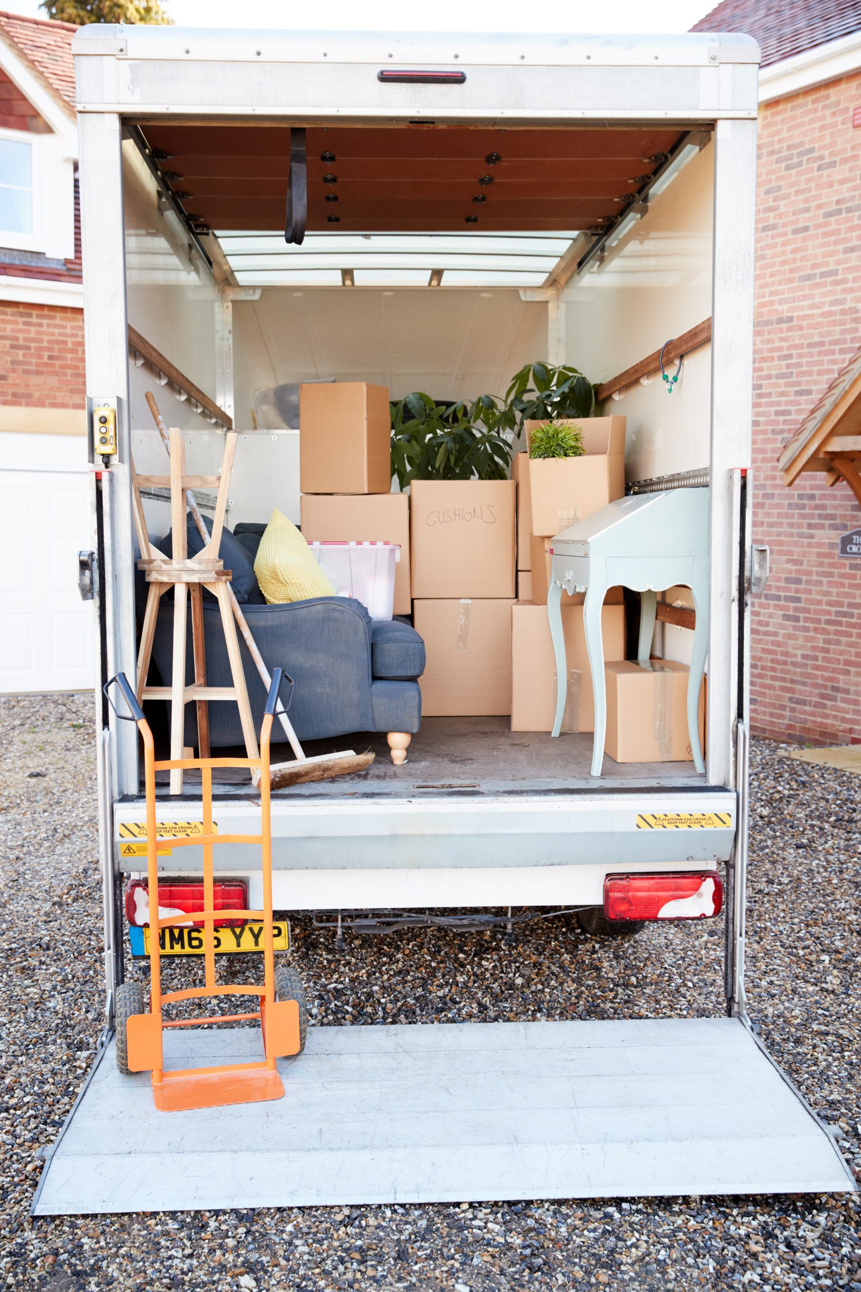 Removal Truck Waiting To Be Unloaded Outside New Home On Moving Day Removal Truck Waiting To Be Unloaded Outside New Home On Moving Day